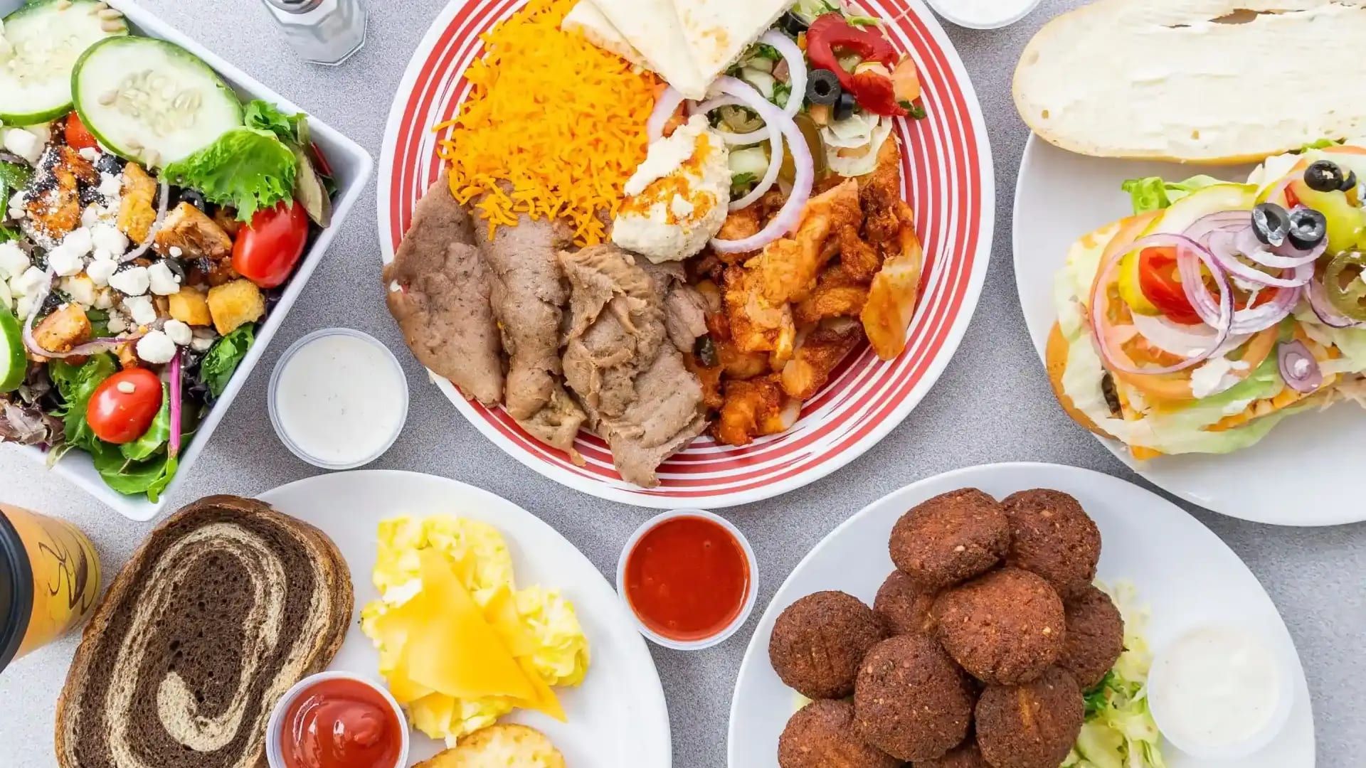 Shawarma and falafel plates with rice, hummus, salad and pita